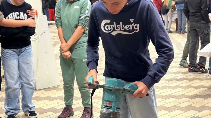 JHW-Wipptal Mädchen bedient Betonmischer, andere beobachten beim handwerklichen Workshop
