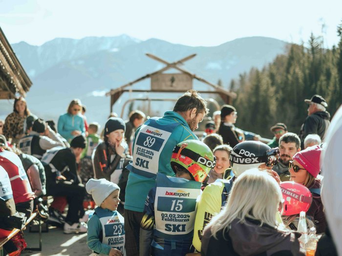 lvh Wintersportfest in Feldthurns Skifahrer und Zuschauer versammeln sich im Freien bei sonnigem Wetter in den Bergen