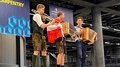 WorldSkills 2022 Special Edition: Zimmerer Marcel Bolego holt Silbermedaille Drei Musiker in traditioneller Kleidung spielen auf einem Holzpodest