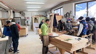 News Menschen in einer Holzwerkstatt bei einer Anleitung