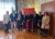 Gruppenfoto von acht Personen vor Fahnen und rotem Stadt Bozen Schild