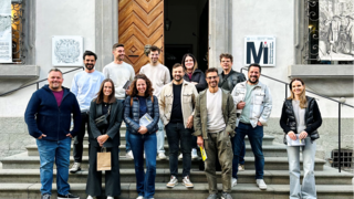 News Gruppe von 13 Personen auf Treppe vor historischem Gebäude