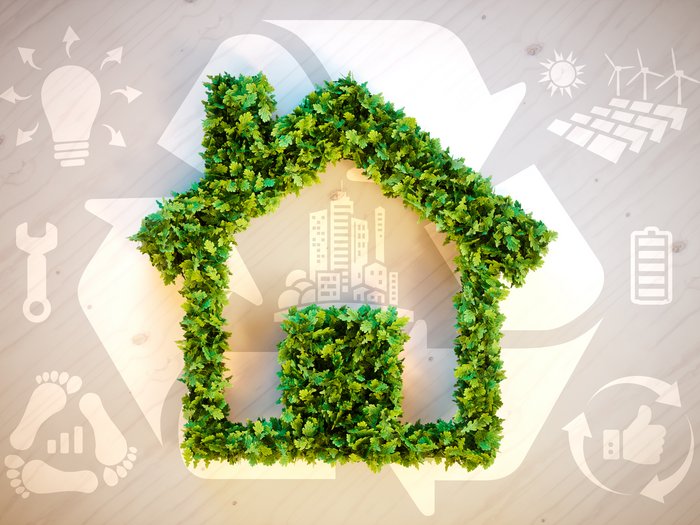 L'adeguamento dei criteri sugli incentivi energetici viene favorevolmente accolto da lvh.apa Casa fatta di foglie verdi con simboli ambientali per edilizia sostenibile