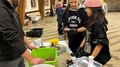 JHW-Wipptal Personen formen Hackfleisch in einer Halle mit Fleischwolf auf dem Tisch