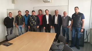 © lvh.apa Neun Männer in einem Besprechungsraum vor einem Whiteboard