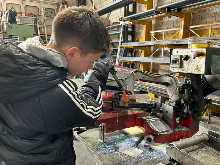 Handwerk zum Anfassen: SkillsDay begeistert im Oberpustertal Junge bedient eine Metallbandsäge in einer Werkstatt