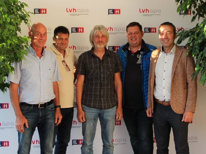 Bauwerksabdichter: Wieder Interessensvertretung im lvh Fünf Männer stehen vor einem LVH APA Hintergrund mit Pflanzen links und rechts