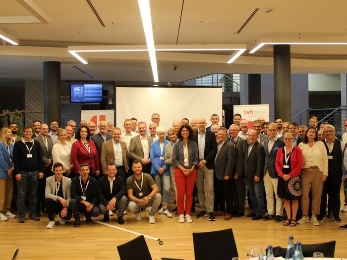 Kfz-Vierländertreffen in Bozen: Wertvoller Austausch und Dialog im Automobilsektor Große Gruppe von Menschen bei einer Konferenz oder Veranstaltung in einem Innenraum