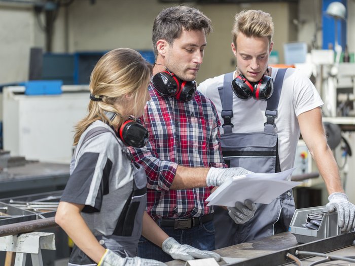 Handwerk in Hafling will weiterhin auf Jugend setzen Drei Fabrikarbeiter besprechen Pläne in der Werkstatt