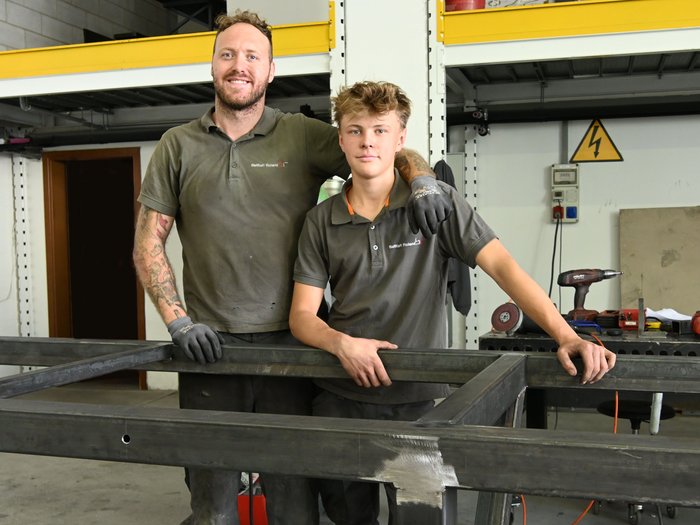 Mettersi all'opera con mani e cuore: l'apprendista fabbro Jakob Lantschner racconta la sua formazione artigianale Due operai in officina dietro una grande struttura metallica