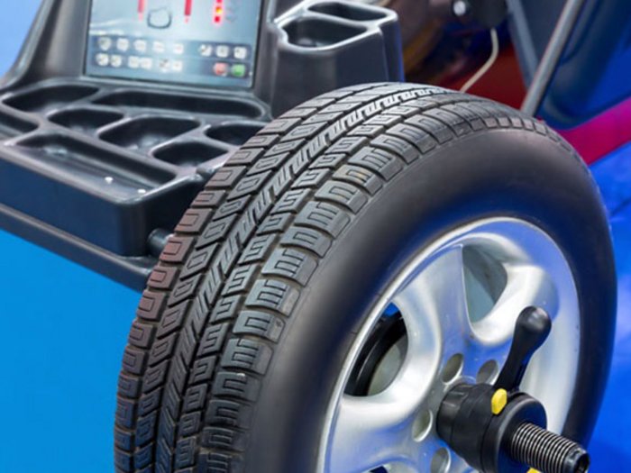 Letzte Chance für Sommerreifen Auto-Reifen auf Auswuchtmaschine in Werkstatt