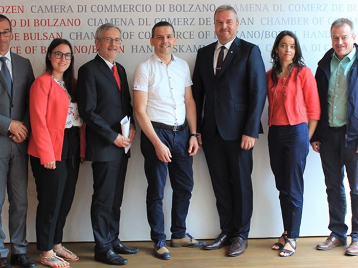 Südtiroler Meisterbund schließt sich der Handelskammer an Sieben Personen posieren stehend vor dem Handelskammer Bozen Hintergrund