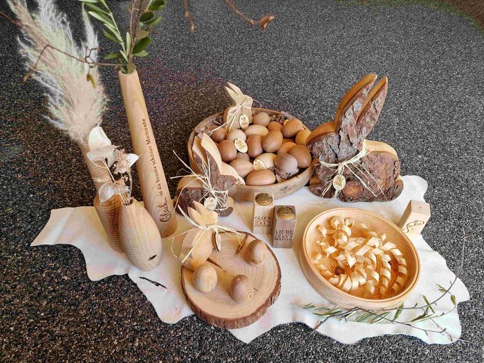 Ostern: Mehr als Osterbrot und Fochaz Ostereier und Hasen aus Holz mit dekorativen Vasen auf weißem Tuch