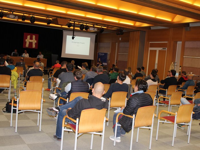 25 anni di Unione Professionale Altoatesina dell’Automobile: con coerenza e lungimiranza verso il futuro Pubblico a una presentazione in una sala conferenze con soffitto in legno