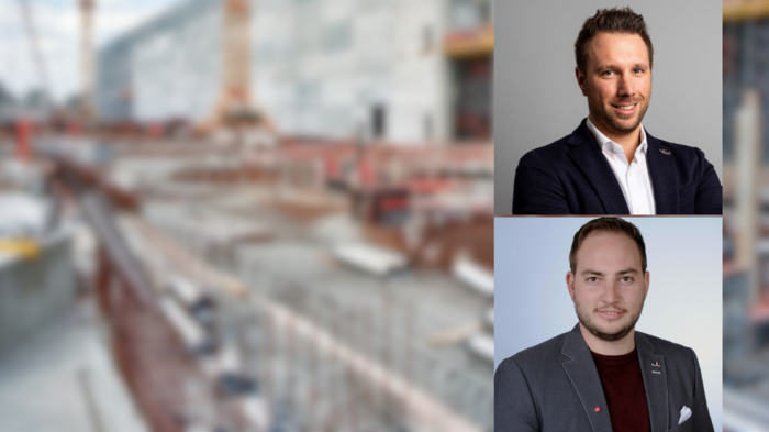 Importanti investimenti nel settore delle costruzioni Due uomini d'affari davanti a un cantiere sfocato