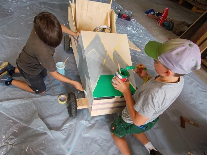 Gara di Soapbox a San Felice: l'artigianato corre veloce Bambini dipingono una macchina di legno in una bottega artigiana