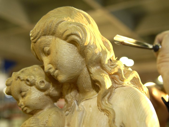 Intagliatori in legno Mano intaglia una scultura in legno di madre con bambino
