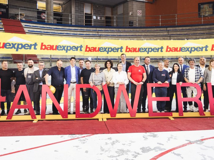 "Avventura artigianato" entusiasma a Merano: i giovani talenti vivono l’artigianato da vicino Gruppo di persone dietro grandi lettere che formano la parola Artigianato in un palazzetto