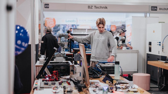 Erfolgreiche Bilanz der Eisacktaler Wirtschaftsschau: rund 20.000 Gäste begeistert Junger Mann bedient einen Roboterarm auf einer Technikmesse