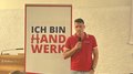 Eppan: Handwerk ist bereit, Verantwortung zu übernehmen Mann hält Mikrofon vor Banner ich bin Handwerk bei Veranstaltung