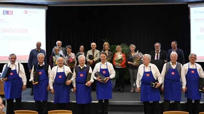 Jahreshauptversammlung der Funktionärinnen und Funktionäre  der Althandwerker/innen Gruppe älterer Menschen bei Ehrung mit Blumen und Geschenken auf Bühne