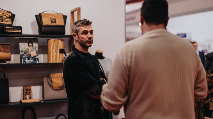 Erfolgreiche Bilanz der Eisacktaler Wirtschaftsschau: rund 20.000 Gäste begeistert Zwei Männer diskutieren vor einem Regal mit Handtaschen und Zubehör