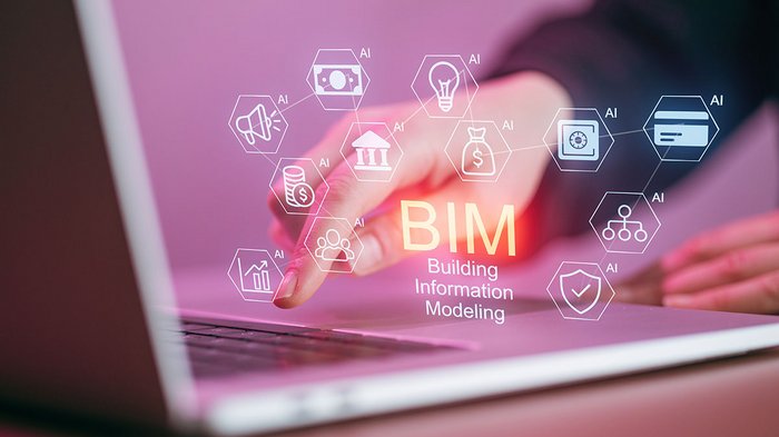 Trasporto studenti: le conseguenze della pandemia si percepiscono ora Mano che tocca laptop con BIM e vari simboli di intelligenza artificiale
