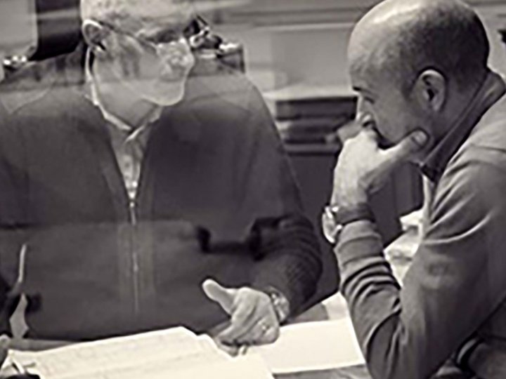 Planit GmbH Due uomini discutono di documenti su un tavolo