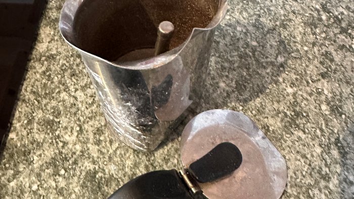 Esplosione in cucina: "È stata la moka" Caffettiera metallica aperta con manico nero su piano di lavoro grigio