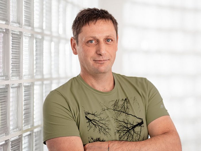 lvh begrüßt Küchlbergtunnel Mann in grünem T-Shirt lehnt an Wand aus Glasbausteinen