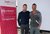 Zwei Männer stehen lächelnd neben einem lvhapa Banner für Handwerksverband