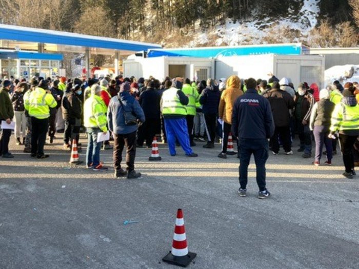Extremzustände für Lkw-Fahrer Menschenmenge vor mobilen Gebäuden in bergiger Landschaft im Winter