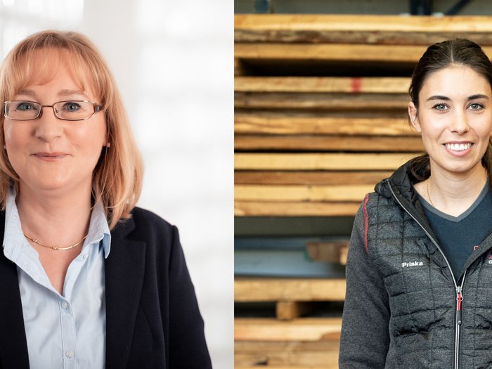 Operatrici economiche oltre la crisi Due donne, una sorridente in abito e l'altra con abbigliamento da lavoro davanti a legname